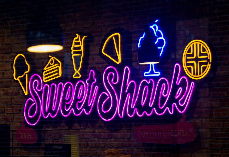 Bright neon sign with sweet treats icons at a dessert shop. Eye-catching and colorful.